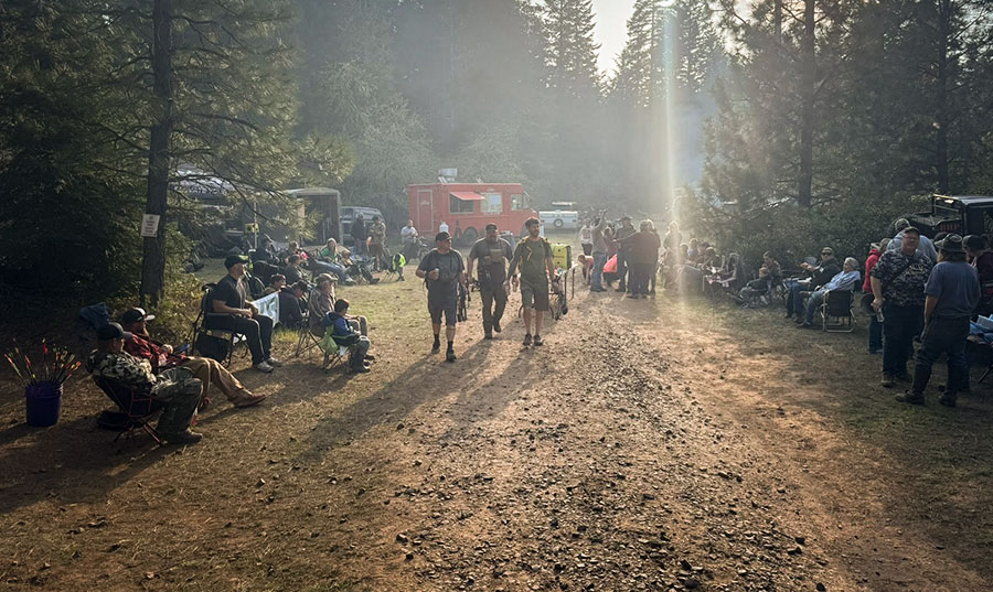 Archers gather along a forest trail at the Klickitat range during a Chinook Archers 3-D shoot weekend